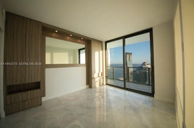 a view of a hallway with wooden floor and a cabinet