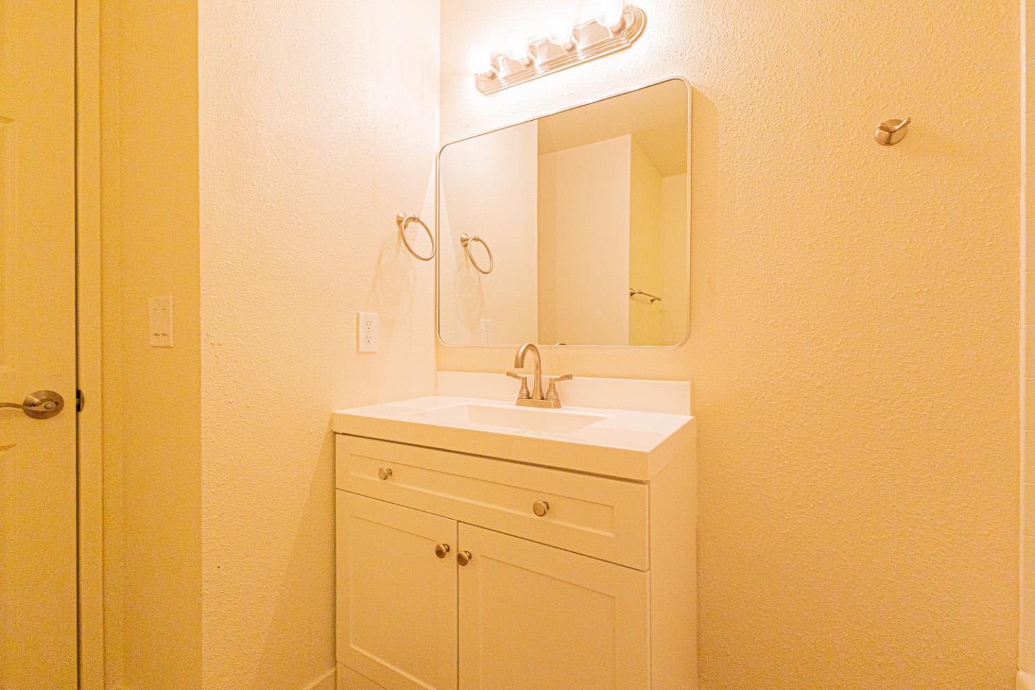 17925 Rodeo Drive Madera, CA 93638 - Photo 14 of 26 a bathroom with a sink and a mirror