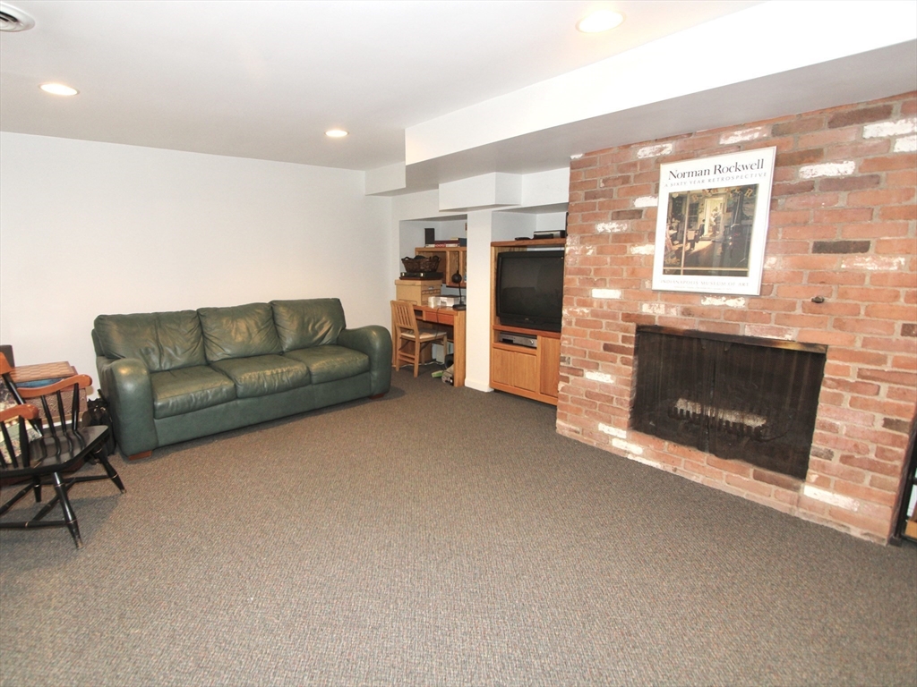 33 Pine Arden Drive West Boylston, MA 01583 - Photo 22 of 32 a living room with furniture a fireplace and a flat screen tv