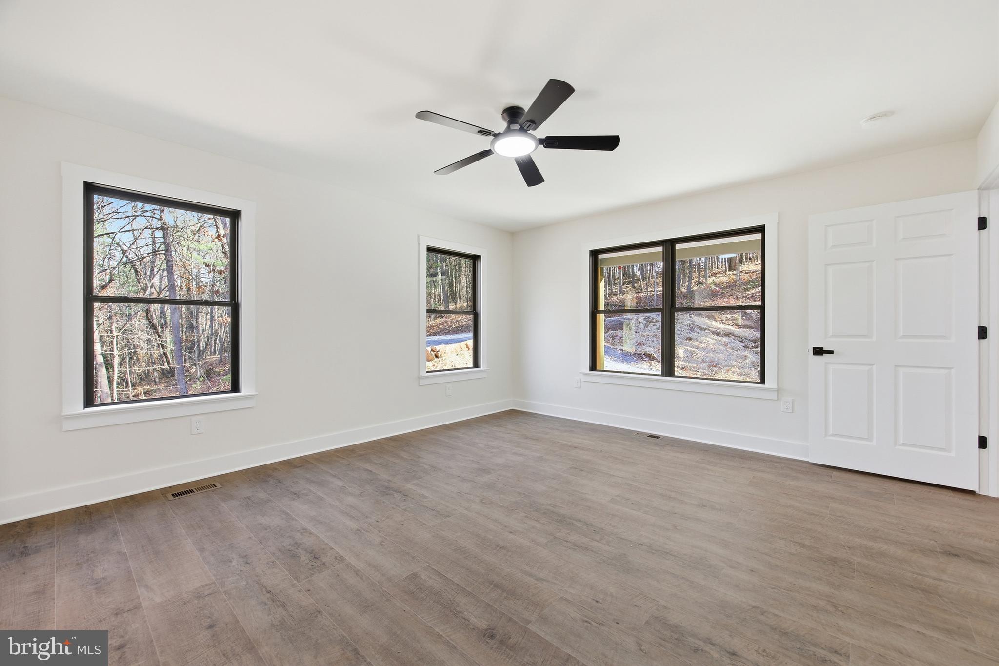 125 Crabapple Road Mount Jackson, VA 22842 - Photo 19 of 51 a view of an empty room with a window and wooden floor