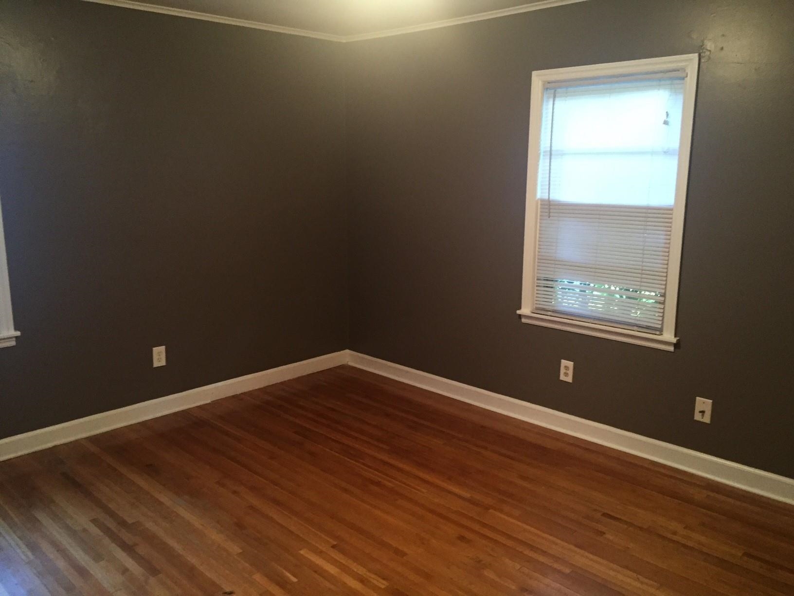 4573 Boyce Road Memphis, TN 38117 - Photo 11 of 18 a view of an empty room with wooden floor and a window