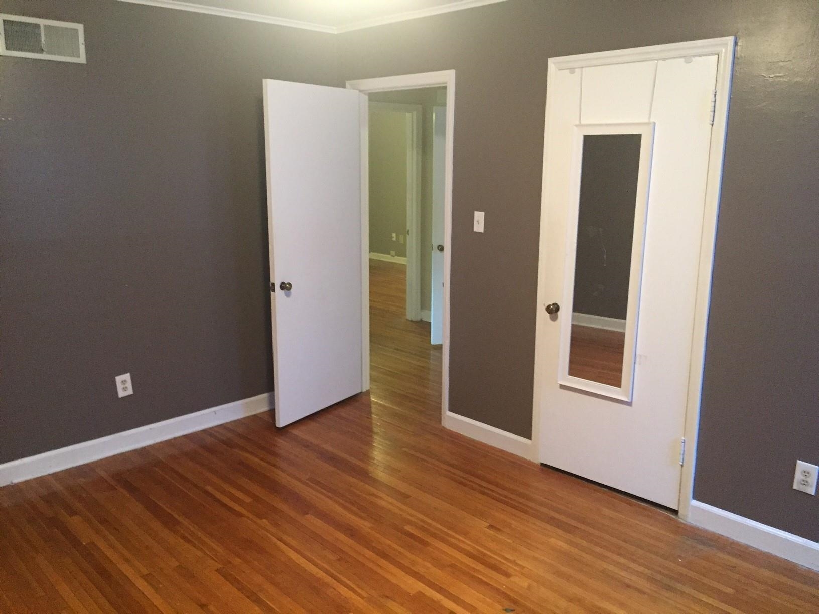 4573 Boyce Road Memphis, TN 38117 - Photo 12 of 18 an empty room with wooden floor and closet