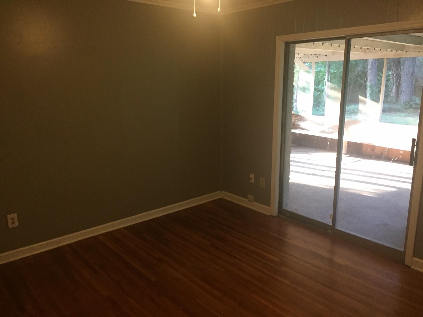 4573 Boyce Road Memphis, TN 38117 - Photo 15 of 18 a view of an empty room with wooden floor and a window