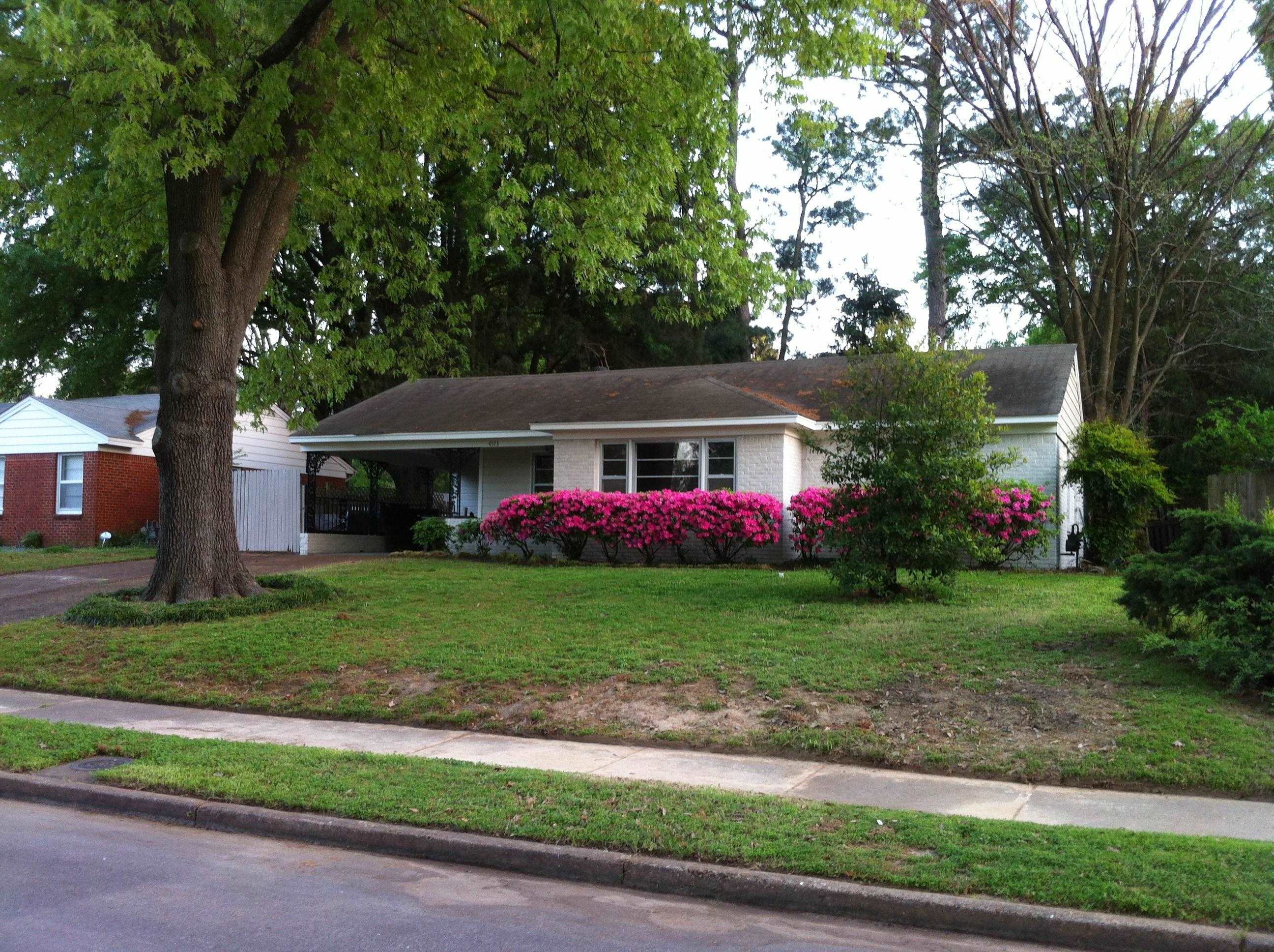 4573 Boyce Road Memphis, TN 38117 - Photo 2 of 18 a front view of a house with porch and garden