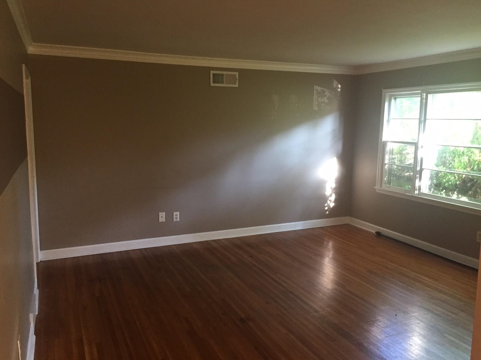 4573 Boyce Road Memphis, TN 38117 - Photo 8 of 18 a view of an empty room with wooden floor and a window