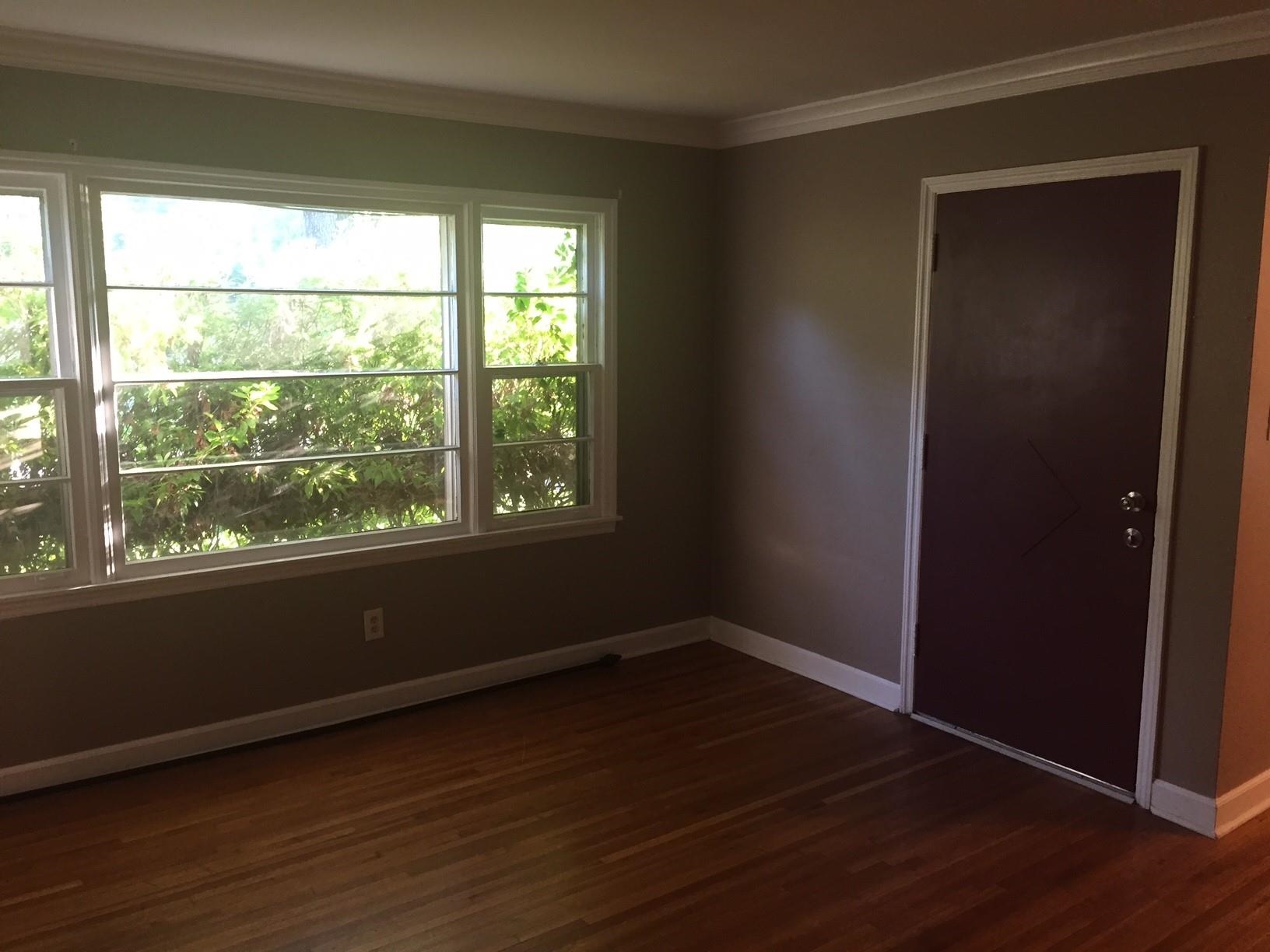 4573 Boyce Road Memphis, TN 38117 - Photo 9 of 18 an empty room with wooden floor and windows