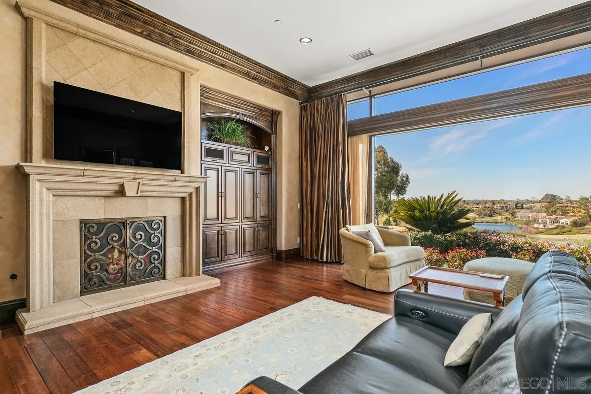 6934 St Andrews Road Rancho Santa Fe, CA 92067 - Photo 23 of 49 a living room with furniture fireplace and flat screen tv