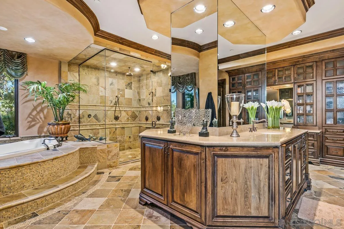 6934 St Andrews Road Rancho Santa Fe, CA 92067 - Photo 26 of 49 a spacious bathroom with a granite countertop sink and a mirror