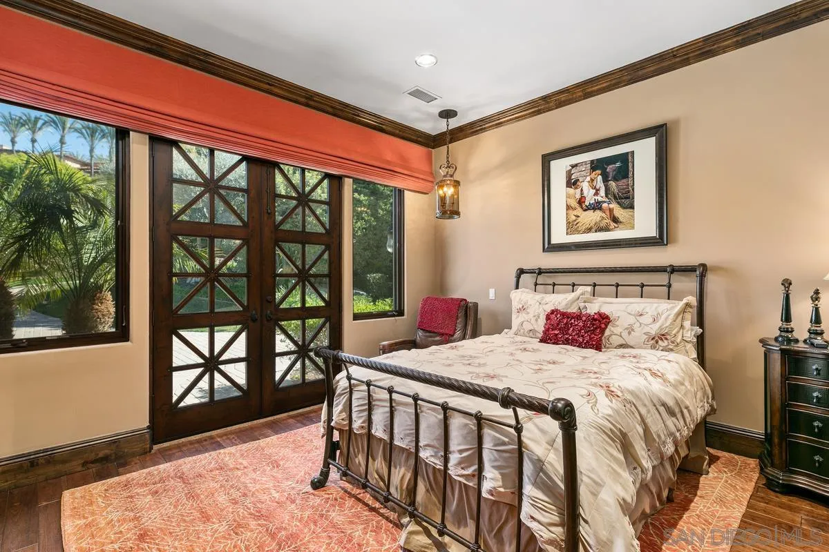 6934 St Andrews Road Rancho Santa Fe, CA 92067 - Photo 29 of 49 a bedroom with a bed and a large window with outer view
