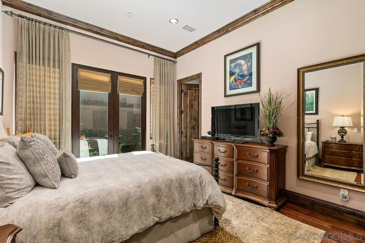6934 St Andrews Road Rancho Santa Fe, CA 92067 - Photo 33 of 49 a bedroom with a large bed and a flat screen tv
