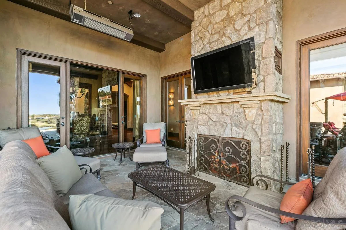 6934 St Andrews Road Rancho Santa Fe, CA 92067 - Photo 36 of 49 a living room with furniture a flat screen tv and a fireplace
