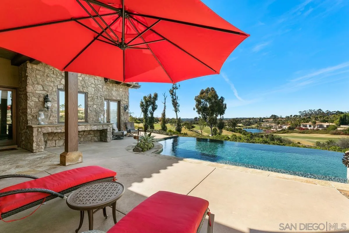 6934 St Andrews Road Rancho Santa Fe, CA 92067 - Photo 37 of 49 a view of swimming pool with a table and chairs under an umbrella