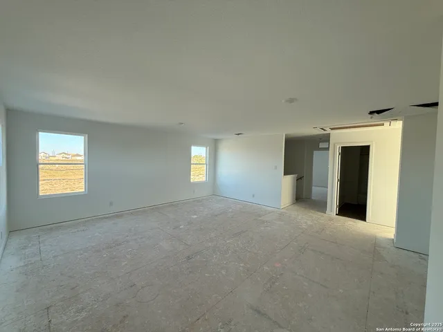 a view of empty room with window and fireplace