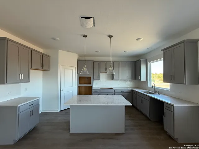 a large kitchen with cabinets and stainless steel appliances