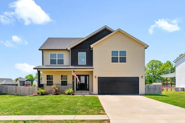 a front view of house with yard and green space