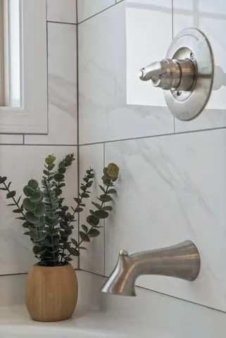 a bathroom with double vanity sinks and a mirror