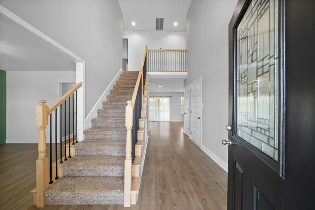 a view of a room with wooden floor