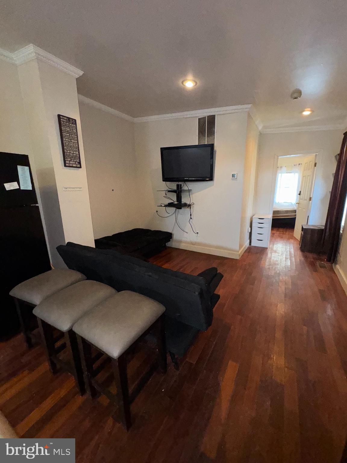 200 South Parrish Street Baltimore, MD 21223 - Photo 11 of 21 a living room with furniture and a flat screen tv