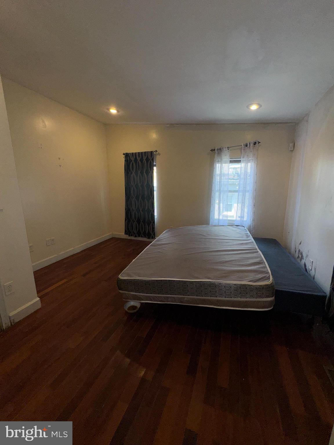 200 South Parrish Street Baltimore, MD 21223 - Photo 12 of 21 a bedroom with a bed and wooden floor