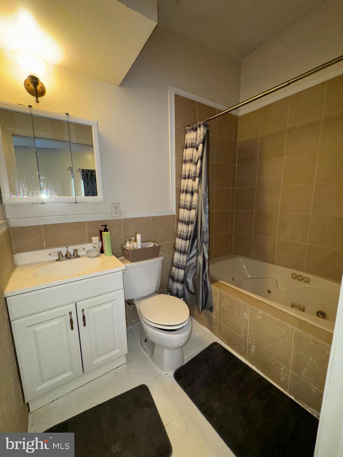 200 South Parrish Street Baltimore, MD 21223 - Photo 13 of 21 a bathroom with a sink a toilet and shower