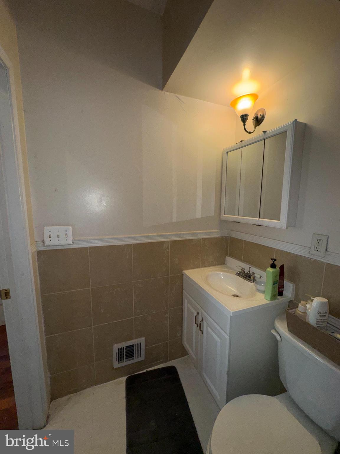 200 South Parrish Street Baltimore, MD 21223 - Photo 14 of 21 a bathroom with a sink a toilet and mirror