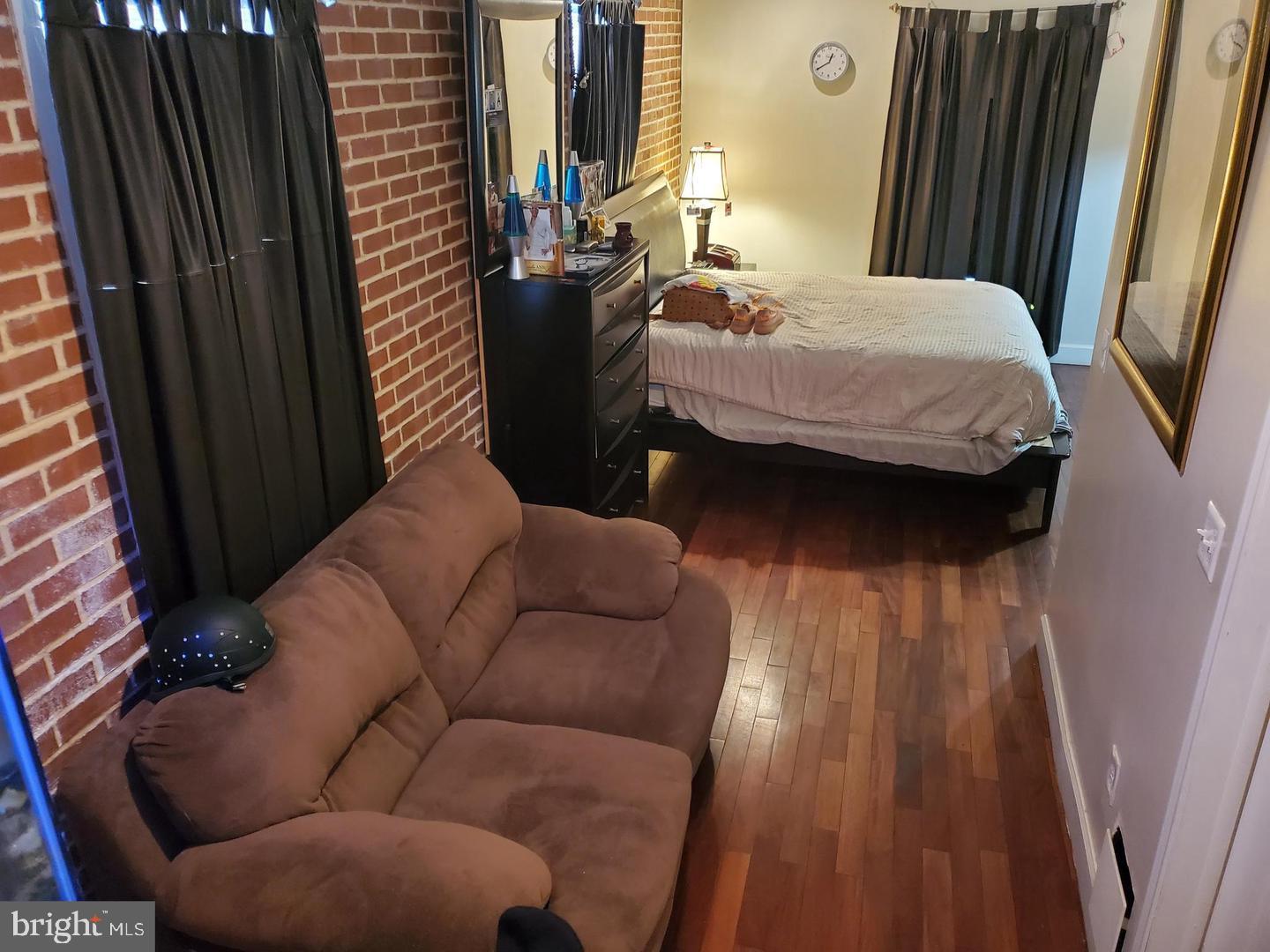 200 South Parrish Street Baltimore, MD 21223 - Photo 2 of 21 a bed sitting in a bedroom next to a window