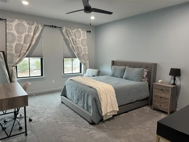 a spacious bedroom with a bed and a window