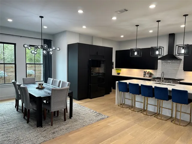 a large kitchen with a table and chairs
