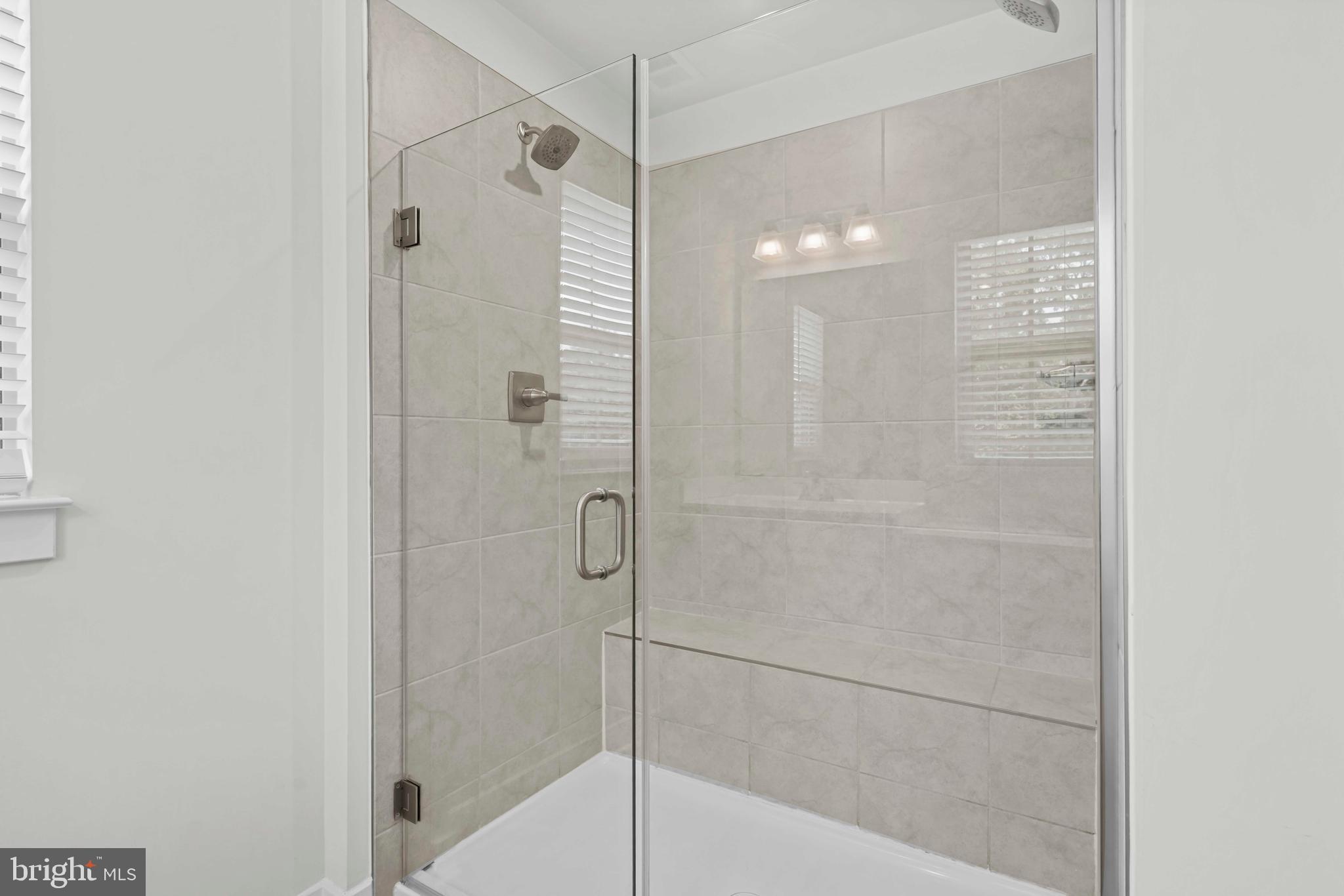 3903 Emory Ridge Road Brandywine, MD 20613 - Photo 21 of 42 a bathroom with a shower and a glass door