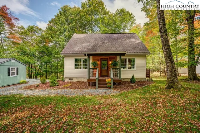 a house view with a sitting space and garden