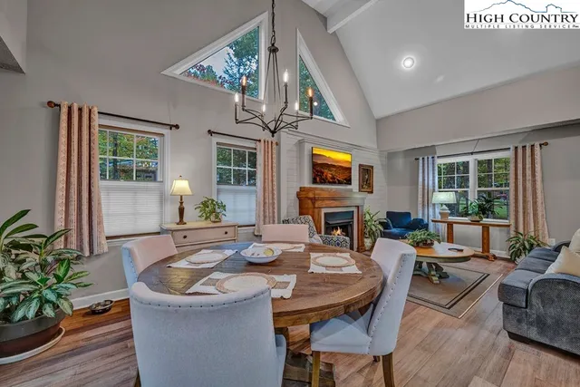 a living room with fireplace furniture and a potted plant