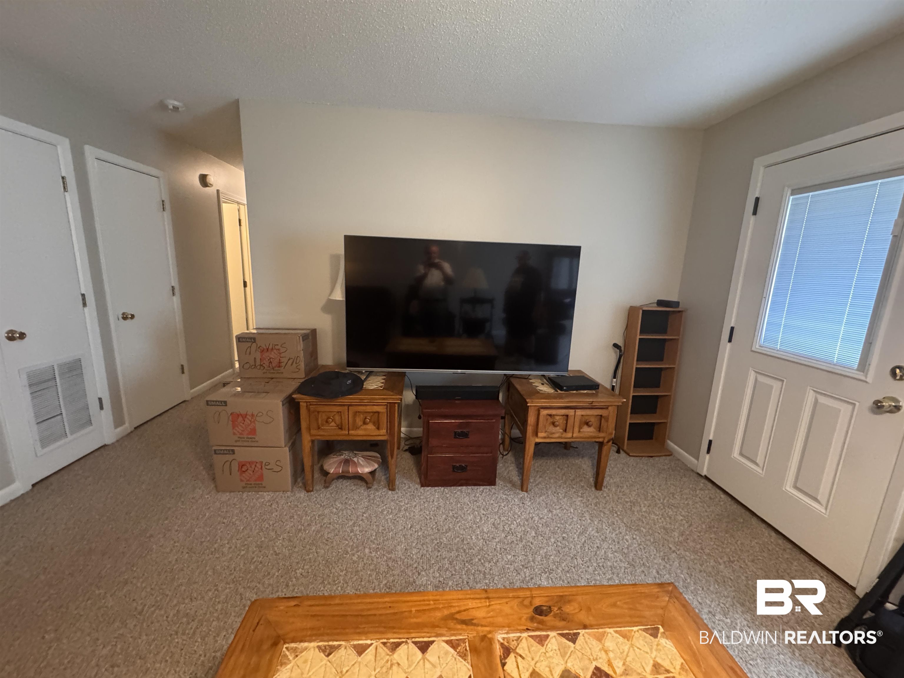15148 Highland Circle Foley, AL 36535 - Photo 7 of 47 Living room featuring carpet floors and a textured ceiling