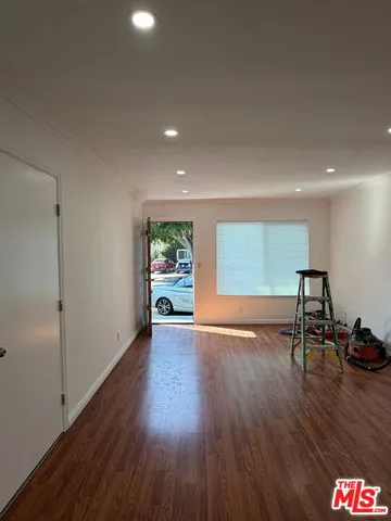 a view of room with furniture and wooden floor