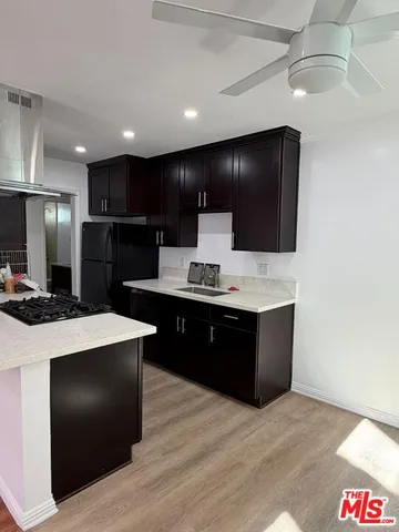 a large kitchen with kitchen island a sink stainless steel appliances and cabinets