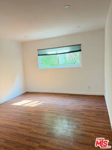 a view of an empty room and a window