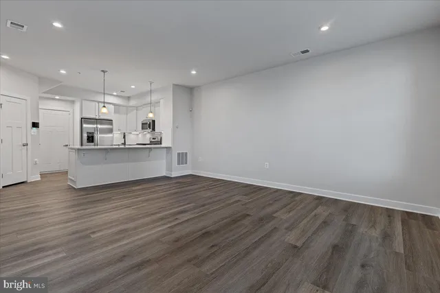 a view of kitchen with wooden floor and window