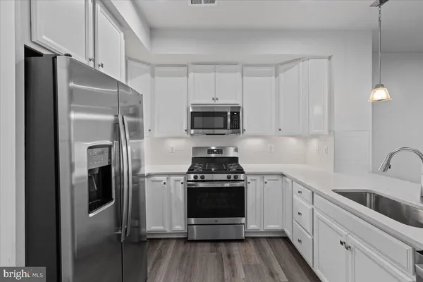 a kitchen with a stove and a refrigerator