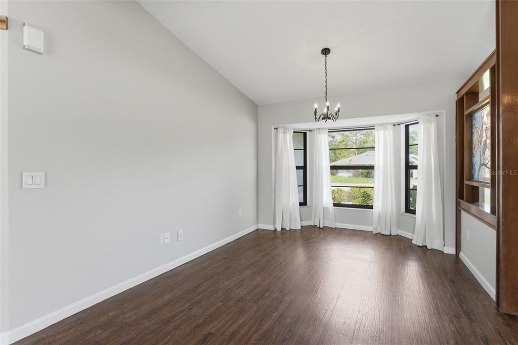 4966 Keysville Avenue Spring Hill, FL 34608 - Photo 8 of 48 a view of wooden floor and windows in a room