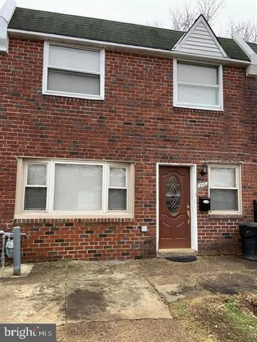 a view of a brick house with large windows