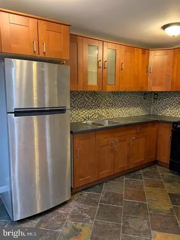 a view of a refrigerator in a kitchen