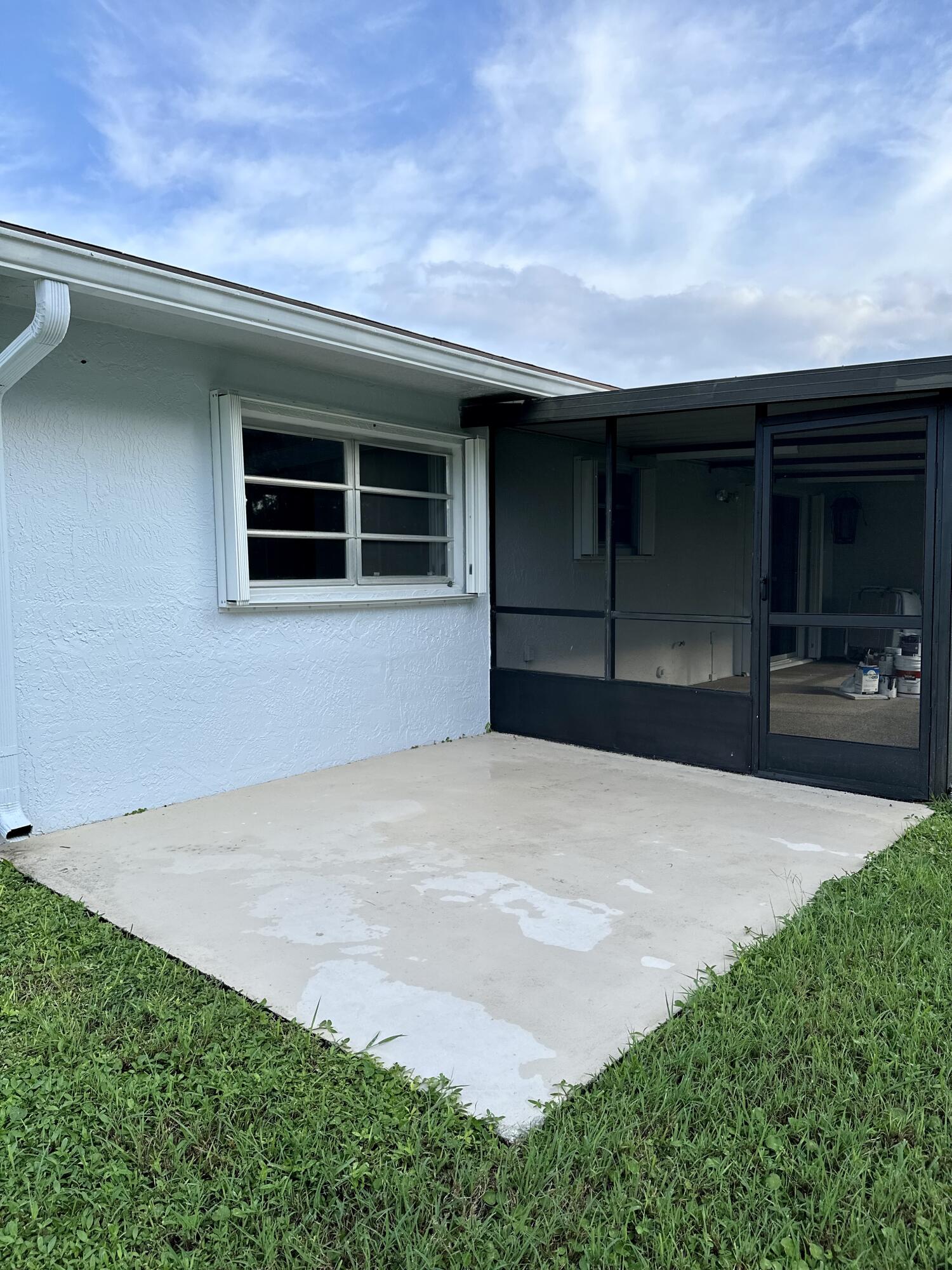 13357 Vía Vesta, Unit B Delray Beach, FL 33484 - Photo 11 of 26 a front view of a house with a yard and garage