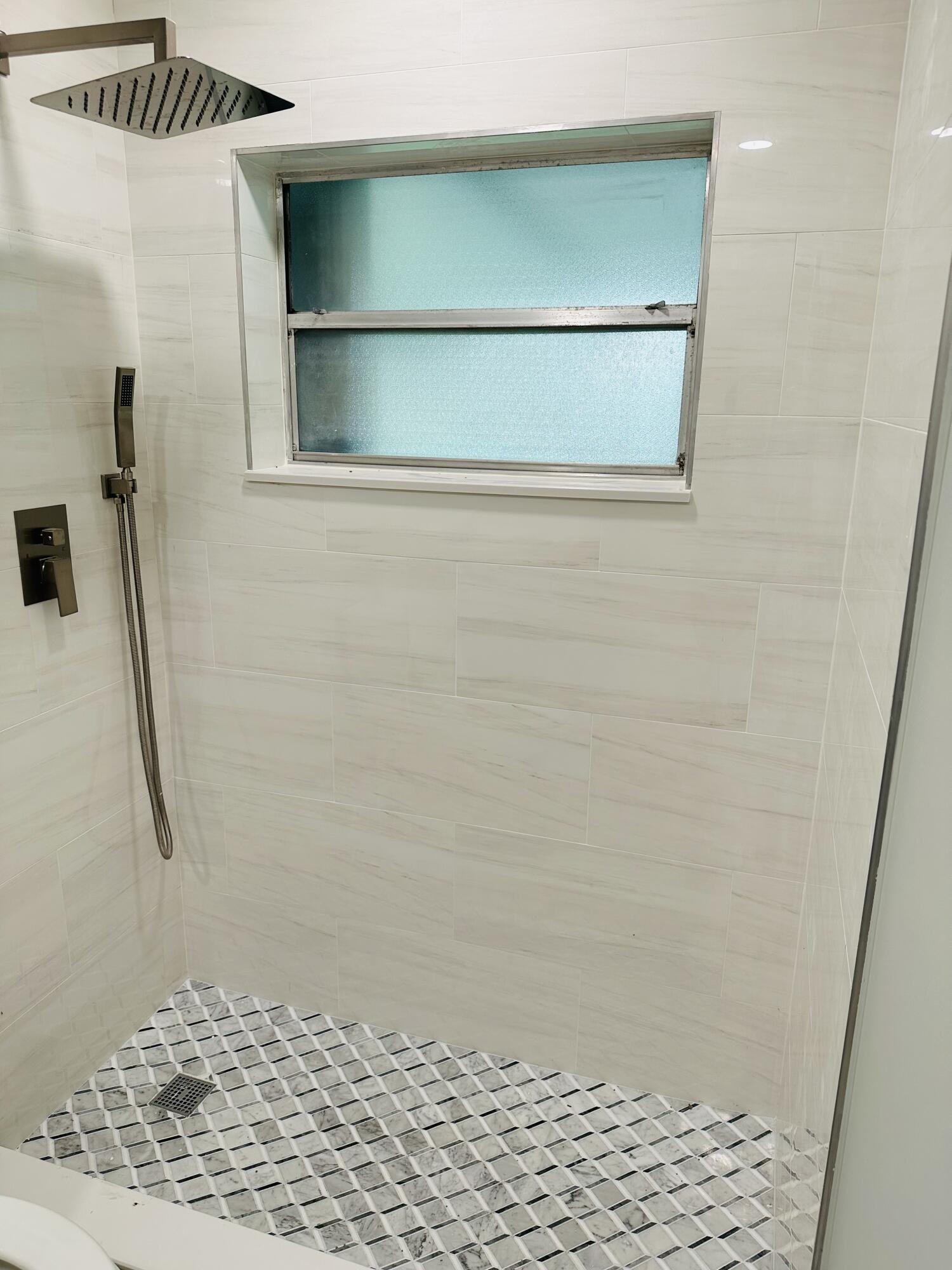 13357 Vía Vesta, Unit B Delray Beach, FL 33484 - Photo 21 of 26 a bathroom with a shower