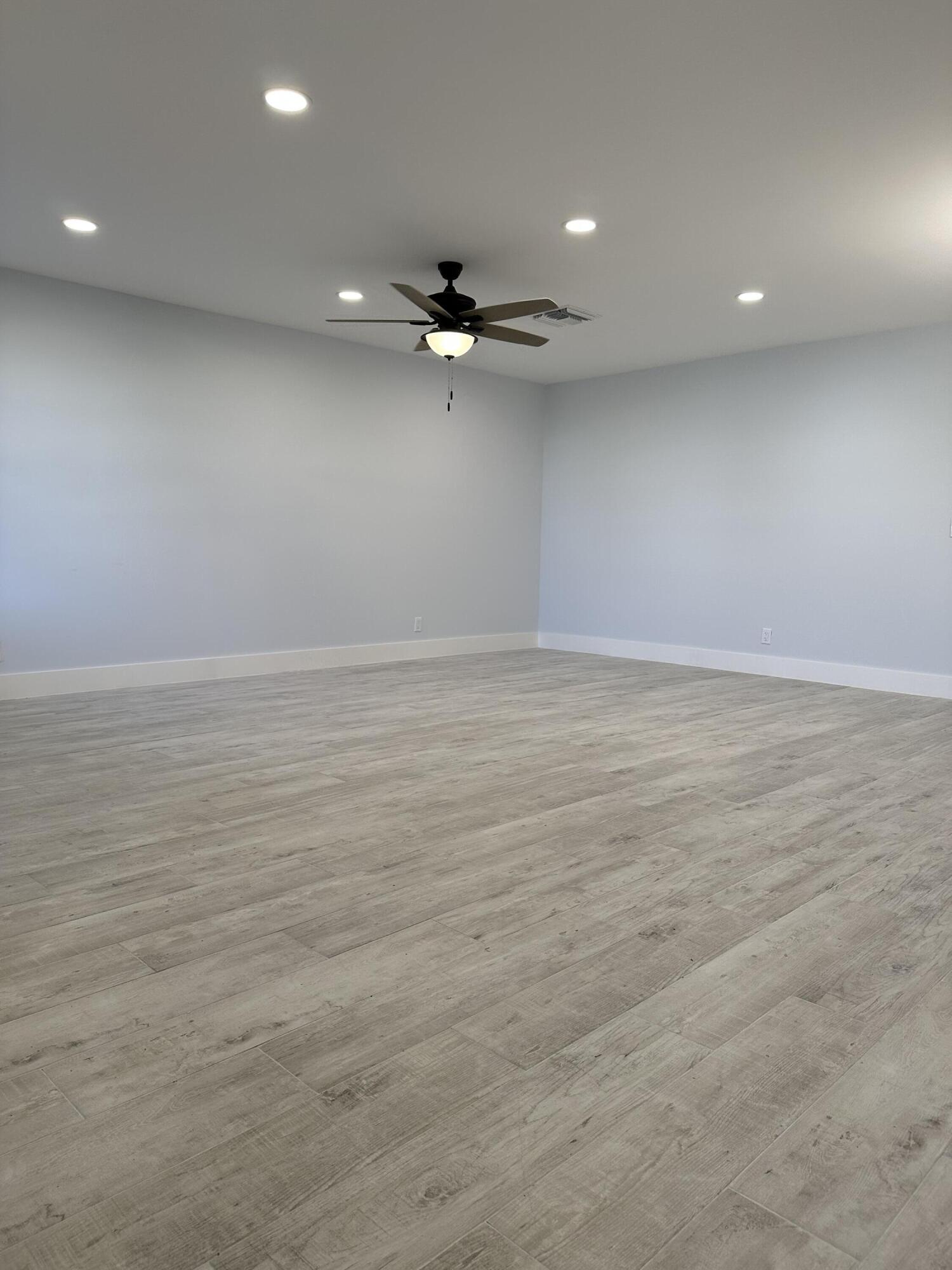 13357 Vía Vesta, Unit B Delray Beach, FL 33484 - Photo 4 of 26 an empty room with a ceiling fan and window