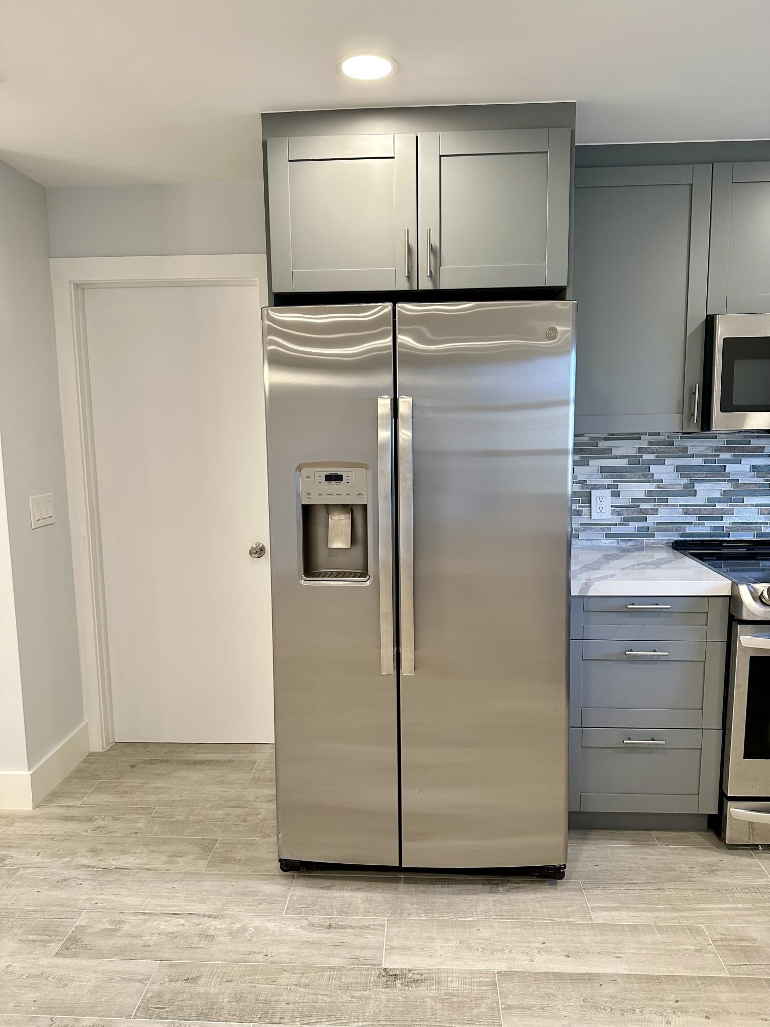 13357 Vía Vesta, Unit B Delray Beach, FL 33484 - Photo 8 of 26 a view of a refrigerator in kitchen and an empty room