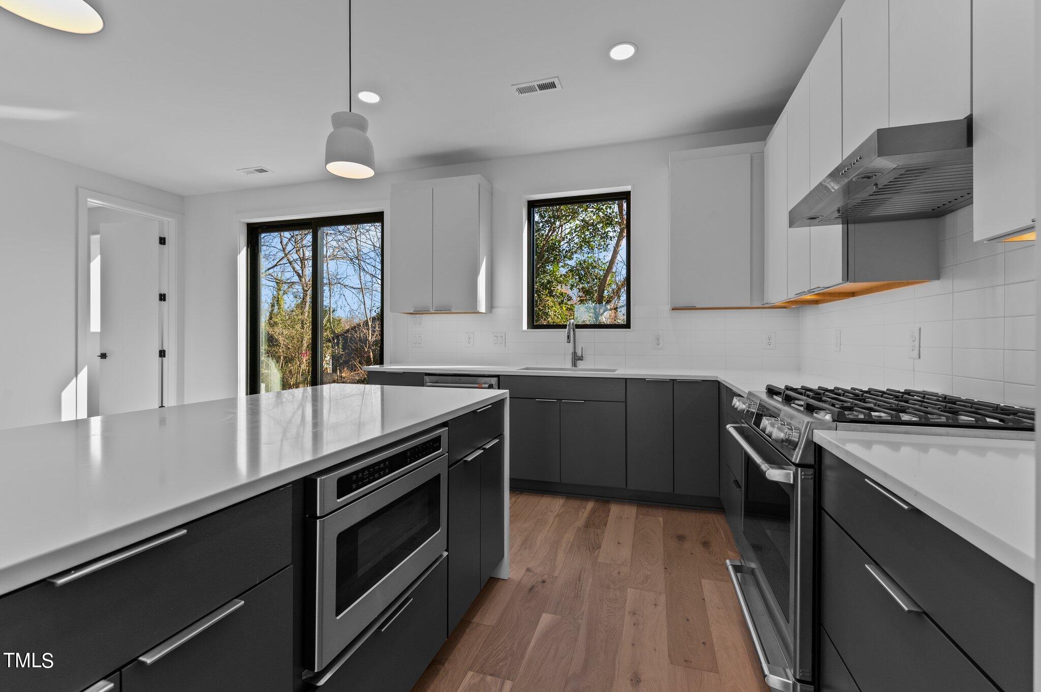 819 South Person Street Raleigh, NC 27601 - Photo 9 of 33 a kitchen with a sink stove and microwave
