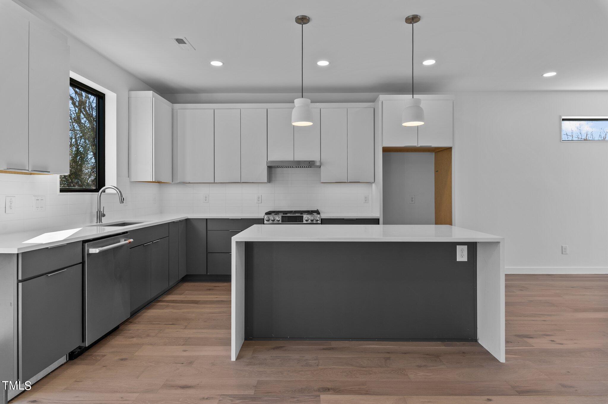 819 South Person Street Raleigh, NC 27601 - Photo 10 of 33 a kitchen with a sink cabinets and window
