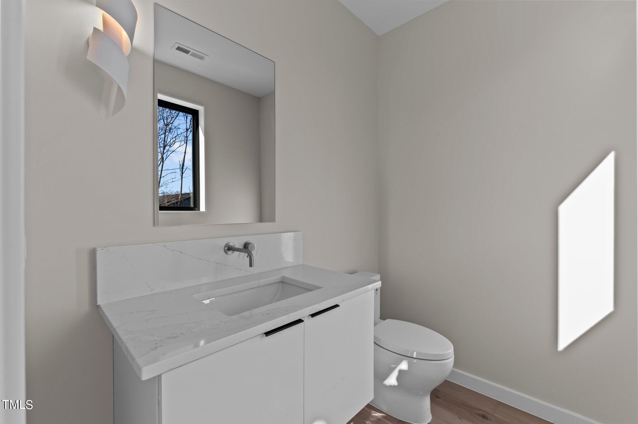 819 South Person Street Raleigh, NC 27601 - Photo 11 of 33 a bathroom with a toilet sink and mirror