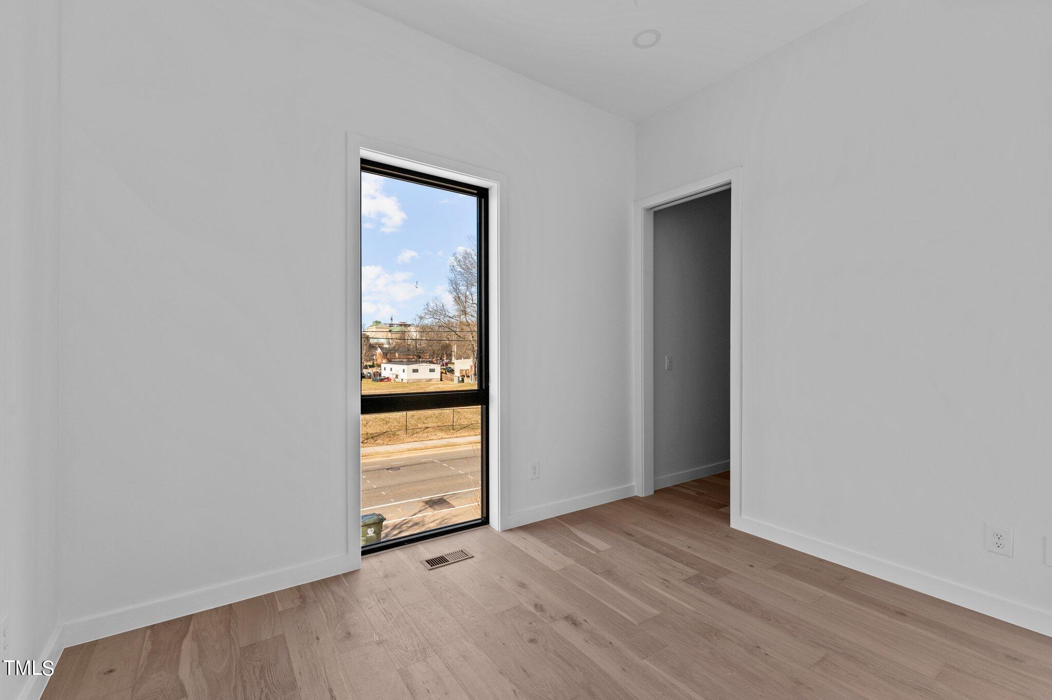819 South Person Street Raleigh, NC 27601 - Photo 13 of 33 an empty room with wooden floor and windows