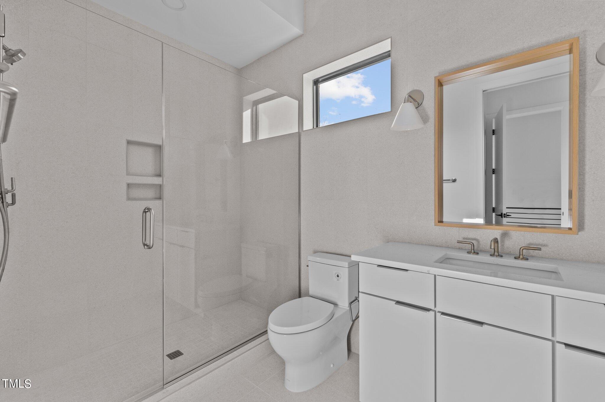 819 South Person Street Raleigh, NC 27601 - Photo 15 of 33 a bathroom with a sink toilet and shower