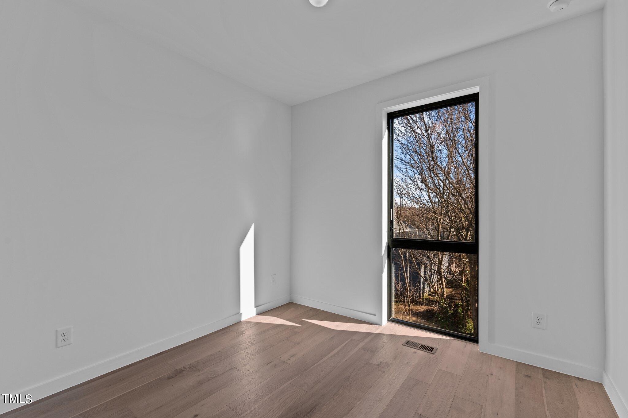 819 South Person Street Raleigh, NC 27601 - Photo 19 of 33 wooden floor in an empty room with a window